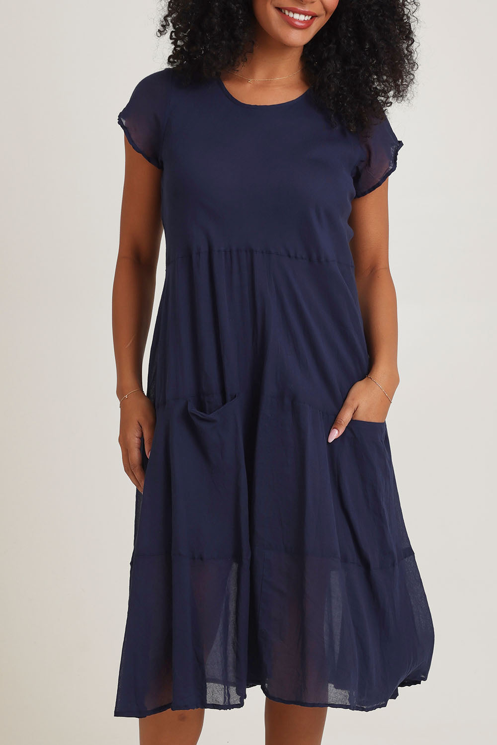 Model Ziara wearing size 10 of the Essentials Bias Pockets Cotton Dress in colour Navy (Blue), from the front, cropped image