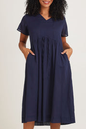 Model Ziara wearing size 10 of the Essentials Tie Waist Cotton Dress in colour Navy (Blue), from the front, cropped image