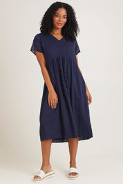 Model Ziara wearing size 10 of the Essentials Tie Waist Cotton Dress in colour Navy (Blue), from the front, showing the whole outfit