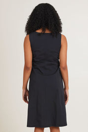 Model Ziara wearing size 10 of the Essentials Pleated Cotton Dress in colour Black (Black), from the back