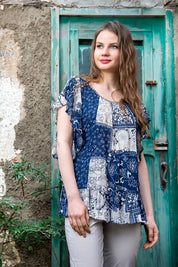 A model wearing the Verona Patchwork Top in colour Patchwork (Blue), from the front, showing the whole outfit