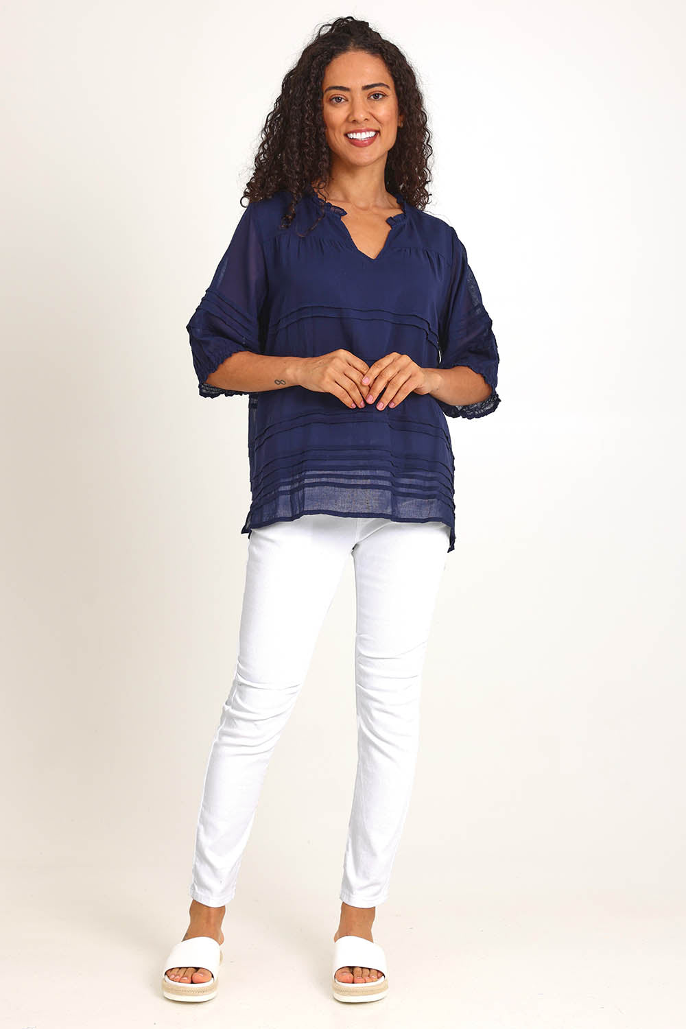 Model Pamelar wearing size 10 of the Essentials Pleated Cotton Top - Navy in colour Navy, from the front
