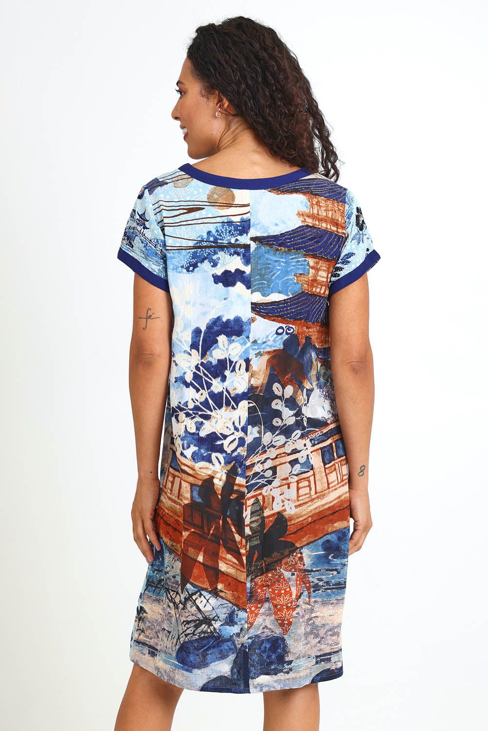 Model Pamelar wearing size 10 of the Patch Dress – Blue in colour Blue, from an angle