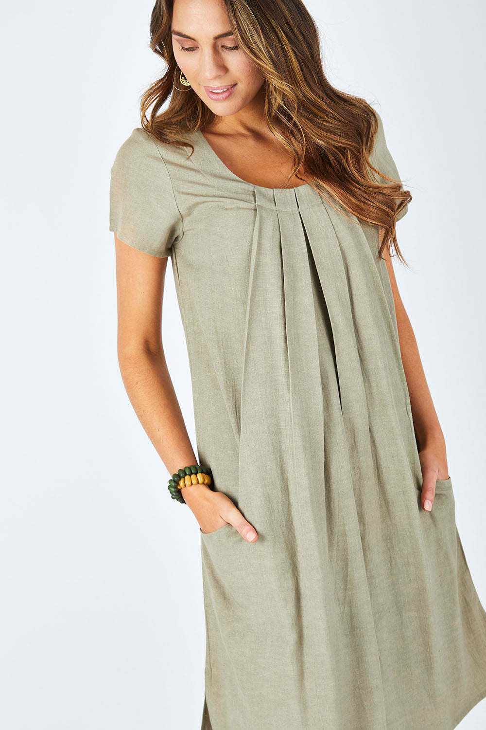 Model Madeline wearing size 10 of the Essential Sleeve Dress in colour Olive (Green), from the front, cropped image