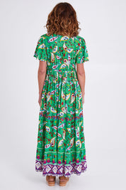 Model Emma wearing size 10 of the Famagusta Cap Sleeve Layers Dress in colour Green (Green), from the back