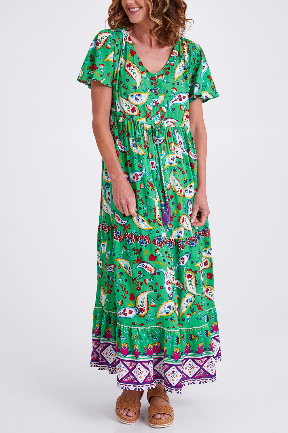Model Emma wearing size 10 of the Famagusta Cap Sleeve Layers Dress in colour Green (Green), from the front, cropped image