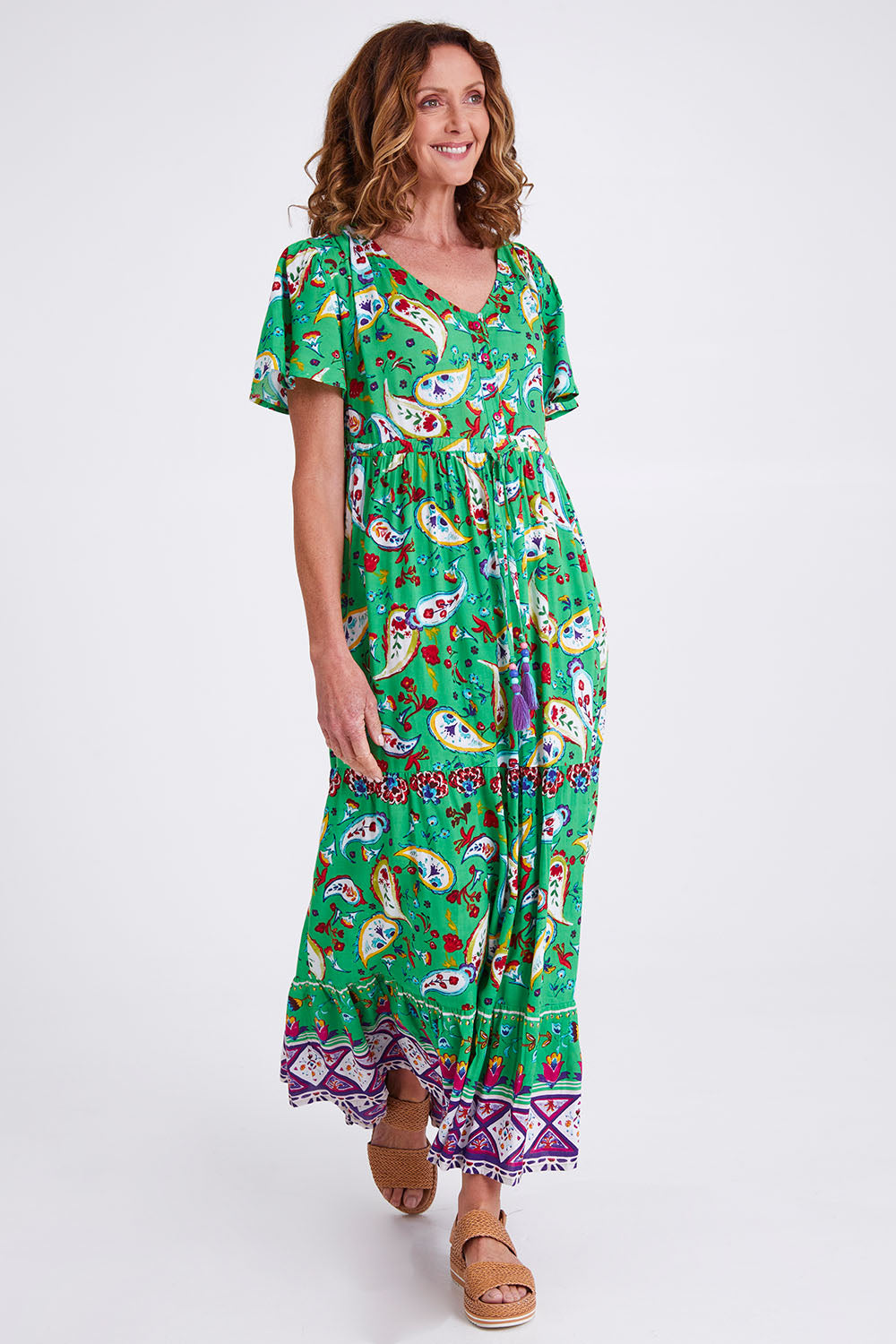 Model Emma wearing size 10 of the Famagusta Cap Sleeve Layers Dress in colour Green (Green), from the front, showing the whole outfit