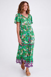 Model Emma wearing size 10 of the Famagusta Cap Sleeve Layers Dress in colour Green (Green), from the front, showing the whole outfit