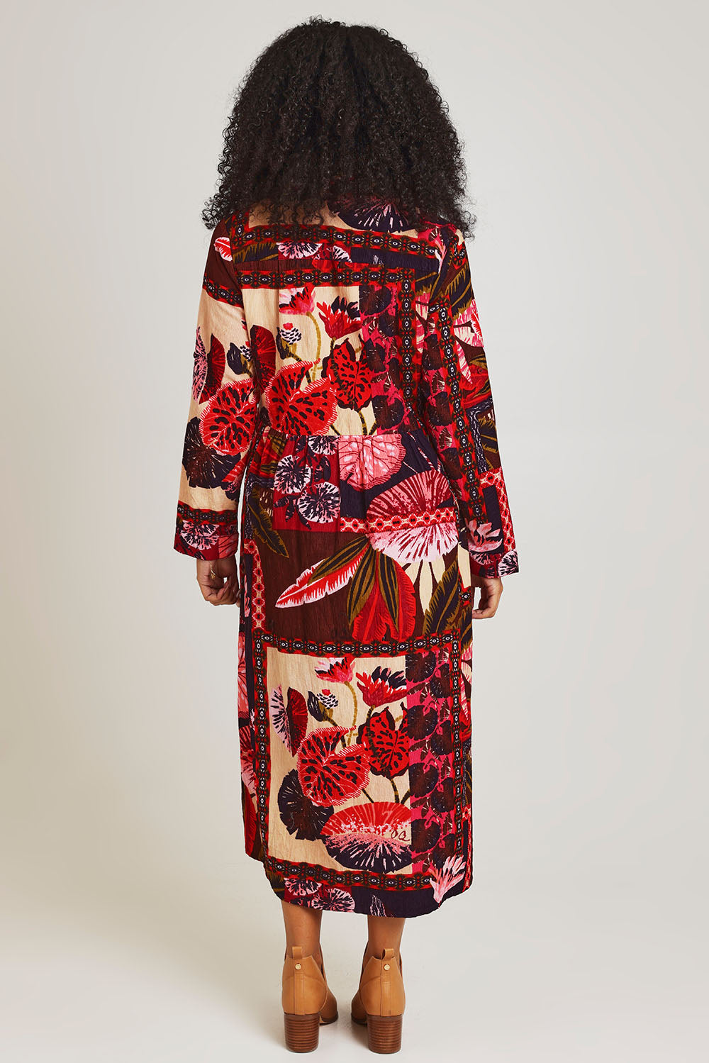 Model Ziara wearing size 10 of the Chandalier Cord Long Collar Dress in colour Chandalier (Red), from the back