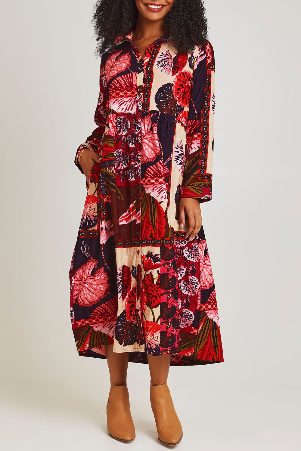Model Ziara wearing size 10 of the Chandalier Cord Long Collar Dress in colour Chandalier (Red), from the front, cropped image