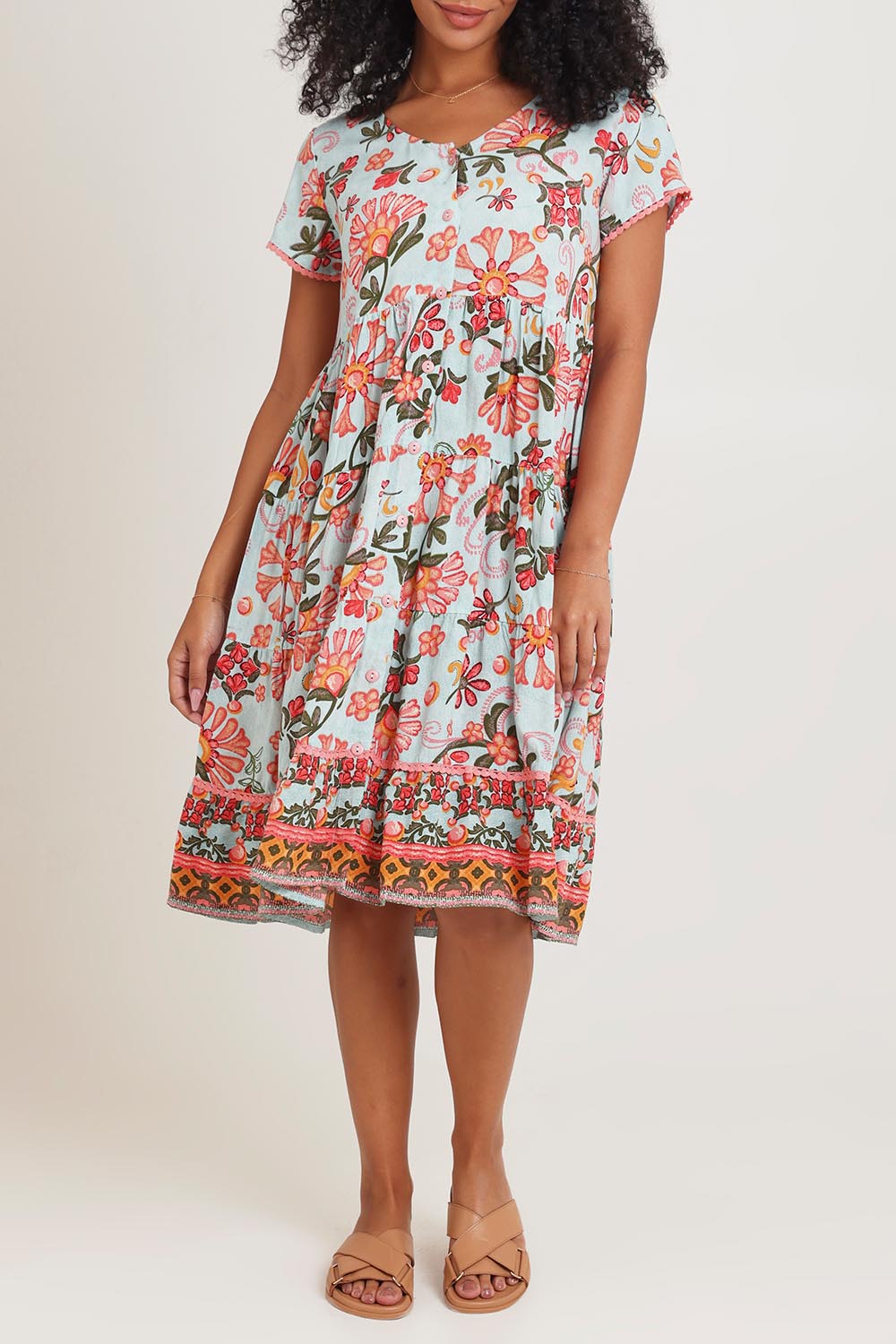 Model Ziara wearing size 10 of the Short Sleeve Layers Dress in colour Macieo, from the front, cropped image