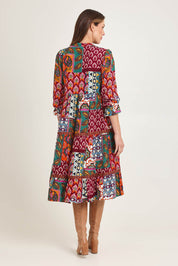 Model Madeline wearing size 10 of the Layers Dress in colour Prato (Red), from the back