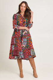 Model Madeline wearing size 10 of the Layers Dress in colour Prato (Red), from the front, showing the whole outfit
