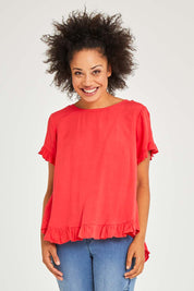 Model Olivia wearing size 10 of the Essentials Linen Blend Frill Top in colour Luscious (Red), from the front, cropped image