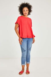 Model Olivia wearing size 10 of the Essentials Linen Blend Frill Top in colour Luscious (Red), from the front, showing the whole outfit