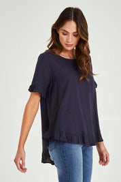 Model Madeline wearing size 10 of the Essentials Linen Blend Frill Top in colour Navy (Blue), from the front, cropped image