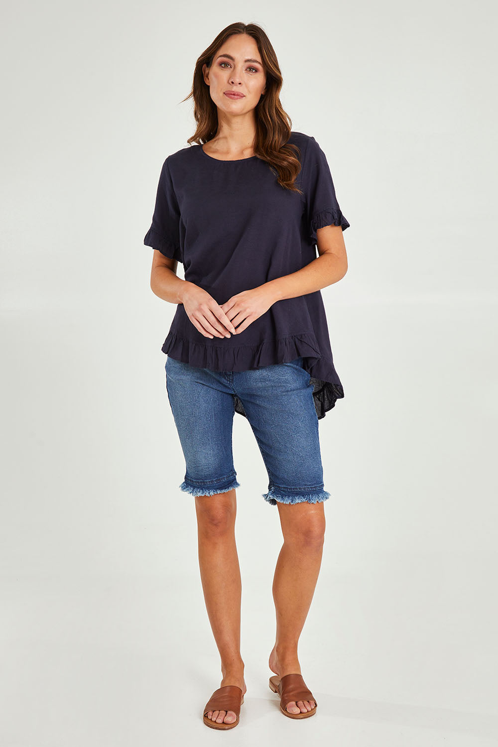 Model Madeline wearing size 10 of the Essentials Linen Blend Frill Top in colour Navy (Blue), from the front, showing the whole outfit
