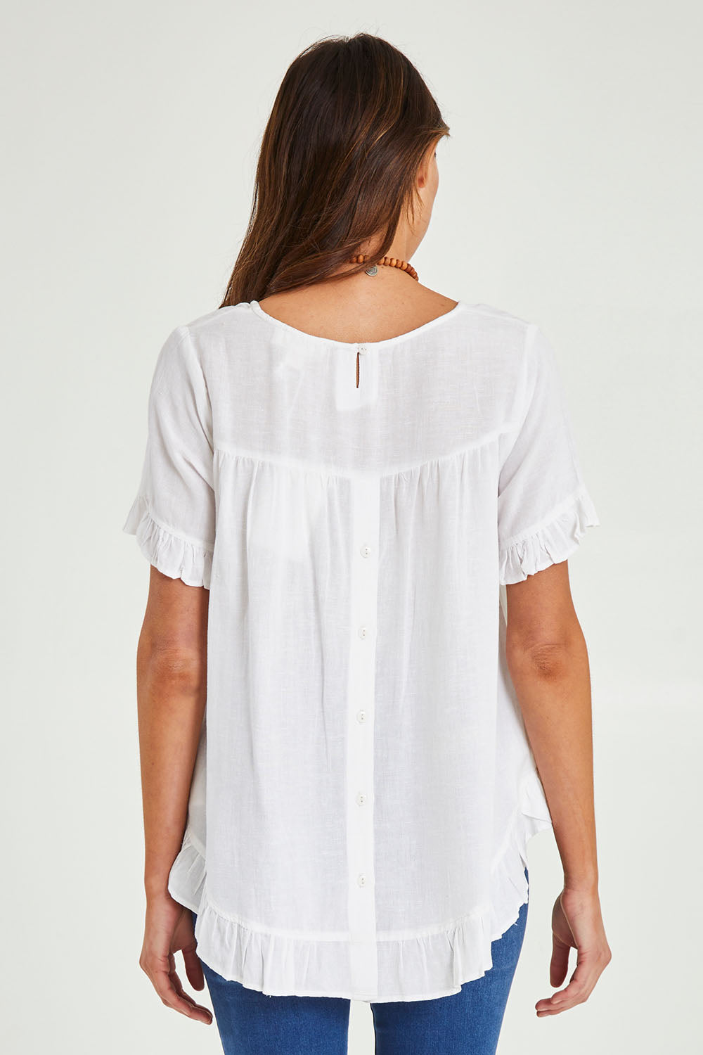 Model Madeline wearing size 10 of the Essentials Linen Blend Frill Top in colour White (White), from the back
