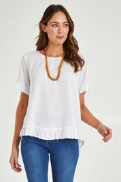 Model Madeline wearing size 10 of the Essentials Linen Blend Frill Top in colour White (White), from the front, cropped image