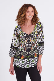 Model Emma wearing size 10 of the Izmir Pleated Boho Top in colour Green (Green), from the front, cropped image