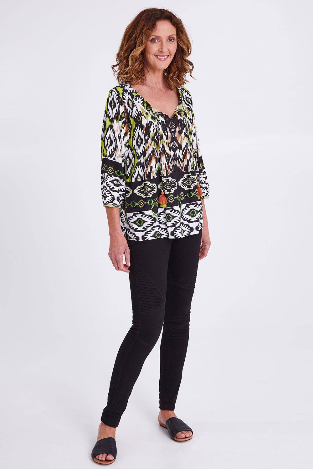 Model Emma wearing size 10 of the Izmir Pleated Boho Top in colour Green (Green), from the front, showing the whole outfit