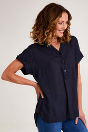 Model Emma wearing size 10 of the Essentials Linen Blend Manderin Collar Top in colour Navy (Blue), from the front, cropped image
