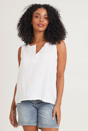 Model Ziara wearing size 10 of the Essentials Linen Blend Frill Top in colour White (White), from the front, cropped image