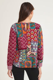 Model Madeline wearing size 10 of the Patch Top in colour Prato, from the back