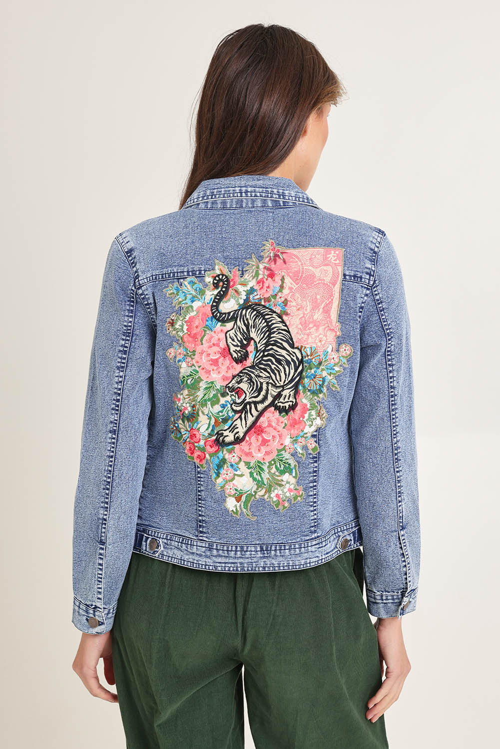 Model Madeline wearing size 10 of the Denim Jacket in colour Keqioa (Blue), from the back