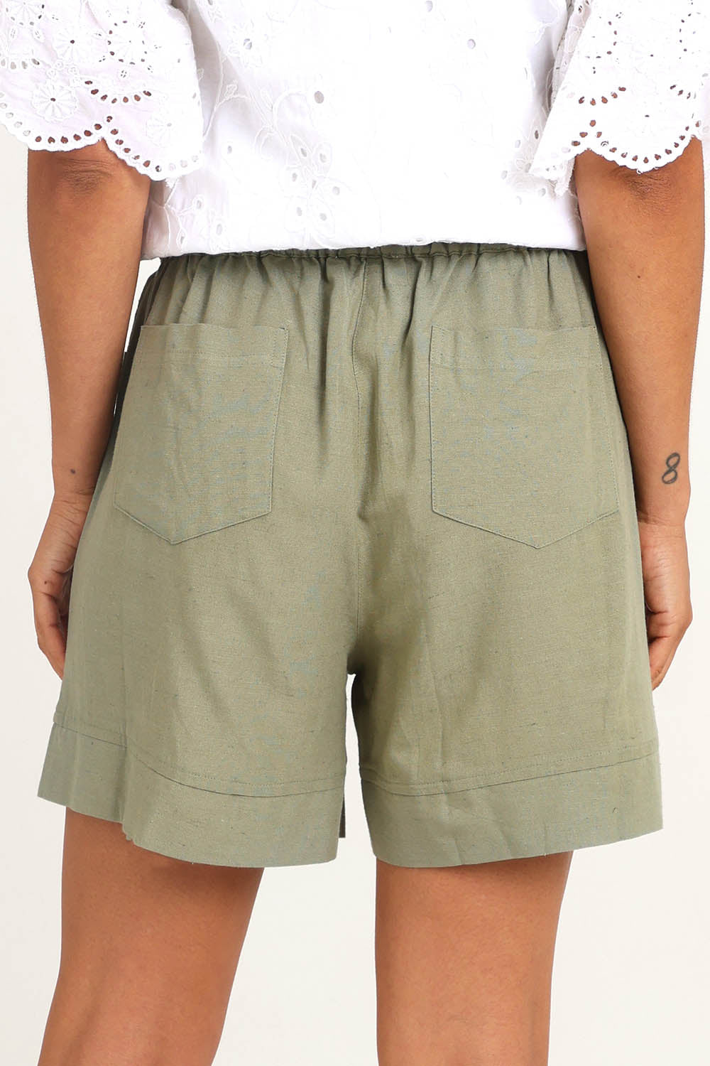 Model Pamelar wearing size 10 of the Essentials Linen Blend Shorts - Khaki in colour Khaki, from the back
