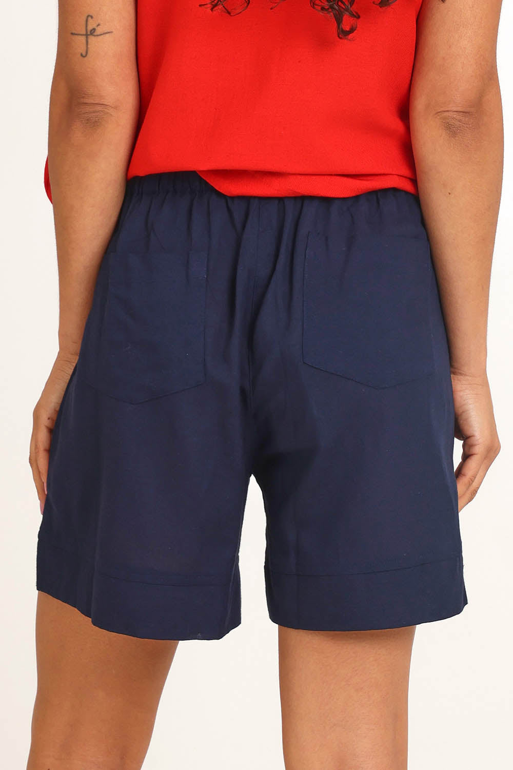 Model Pamelar wearing size 10 of the Essentials Linen Blend Shorts - Navy in colour Navy, from the back