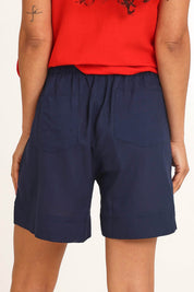 Model Pamelar wearing size 10 of the Essentials Linen Blend Shorts - Navy in colour Navy, from the back