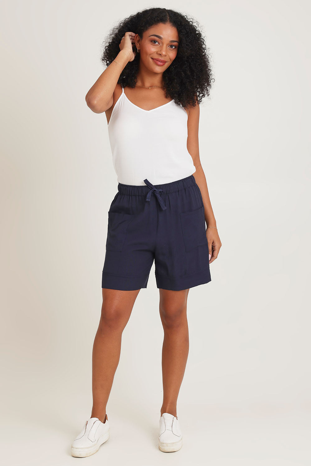 Model Ziara wearing size 10 of the Essentials Linen Blend Shorts in colour Navy (Blue), from the front, showing the whole outfit