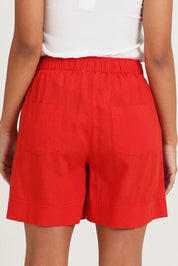 Model Ziara wearing size 10 of the Essentials Linen Blend Shorts in colour Red (Red), from the back