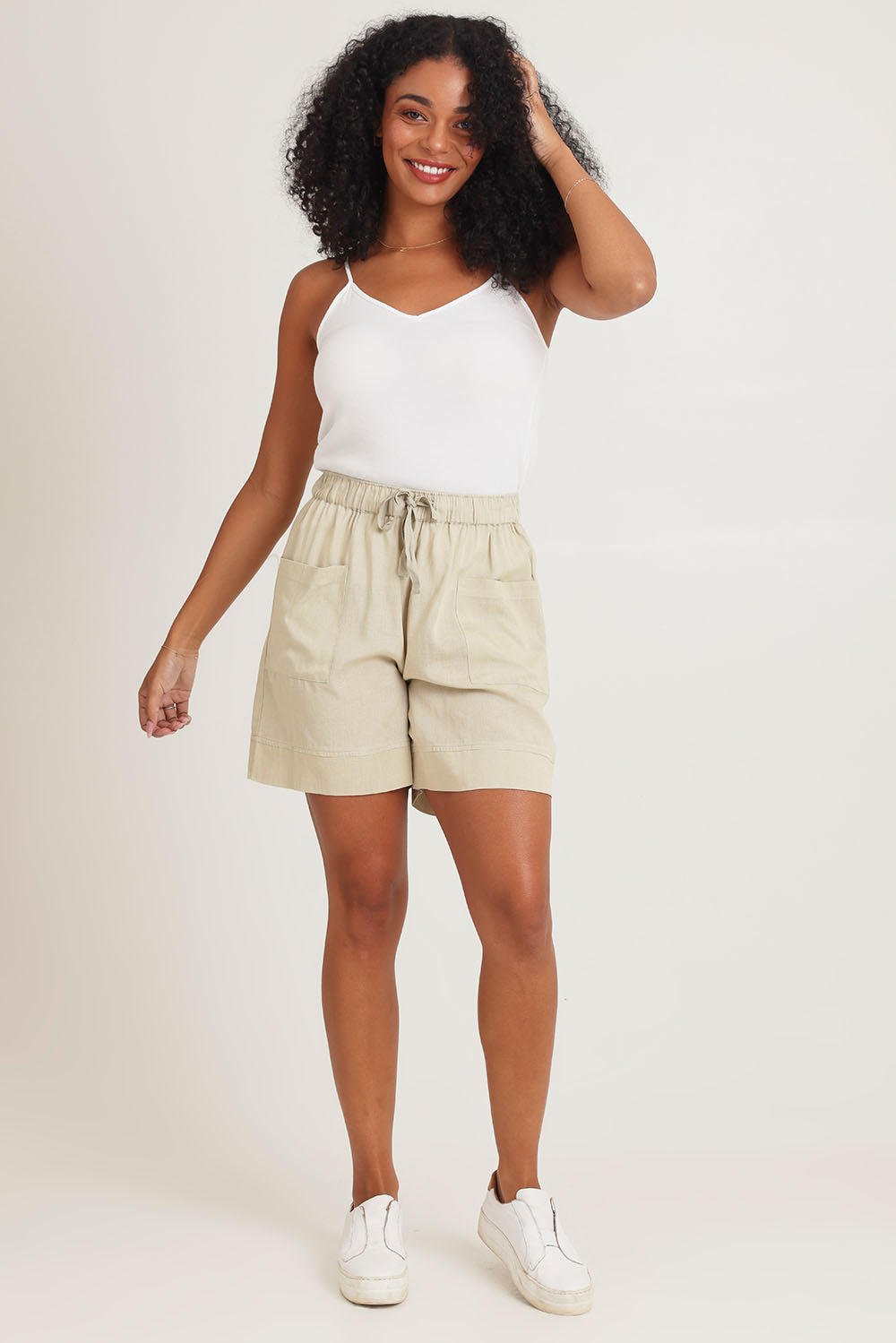 Model Ziara wearing size 10 of the Essentials Linen Blend Shorts in colour Sand, from the front, showing the whole outfit