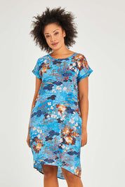 Model Olivia wearing size 10 of the Parga Organic Cotton Simple Cut Dress in colour Print (Blue), from the front, cropped image
