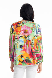 A model wearing the Rio Frill Neck Top in colour Rio (Green), from the back
