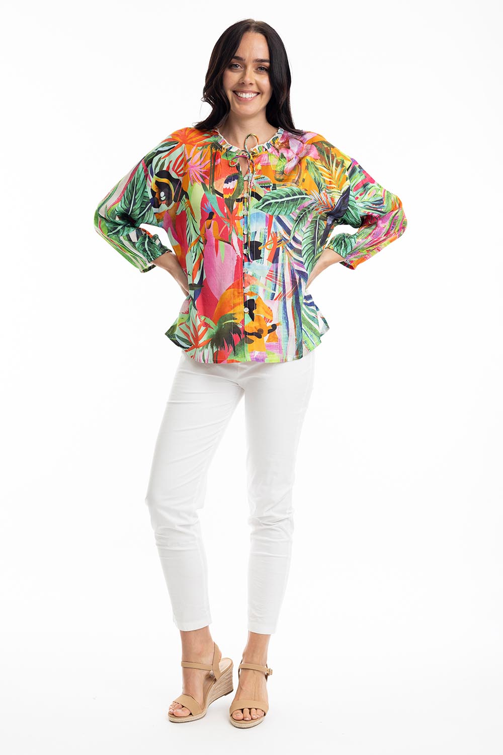 A model wearing the Rio Frill Neck Top in colour Rio (Green), from the front, showing the whole outfit