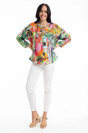 A model wearing the Rio Frill Neck Top in colour Rio (Green), from the front, showing the whole outfit