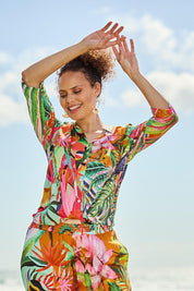 Model Lala wearing size 10 of the Rio Frill Neck Top in colour Rio (Green), from the front, showing the whole outfit