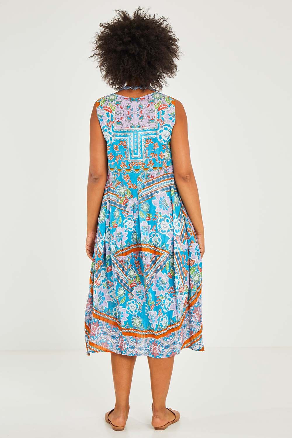 Model Olivia wearing size 10 of the Iruya Organic Cotton Bubble Dress in colour Blue (Blue), from the back