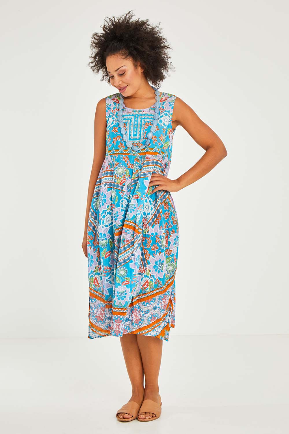 Model Olivia wearing size 10 of the Iruya Organic Cotton Bubble Dress in colour Blue (Blue), from the front, showing the whole outfit