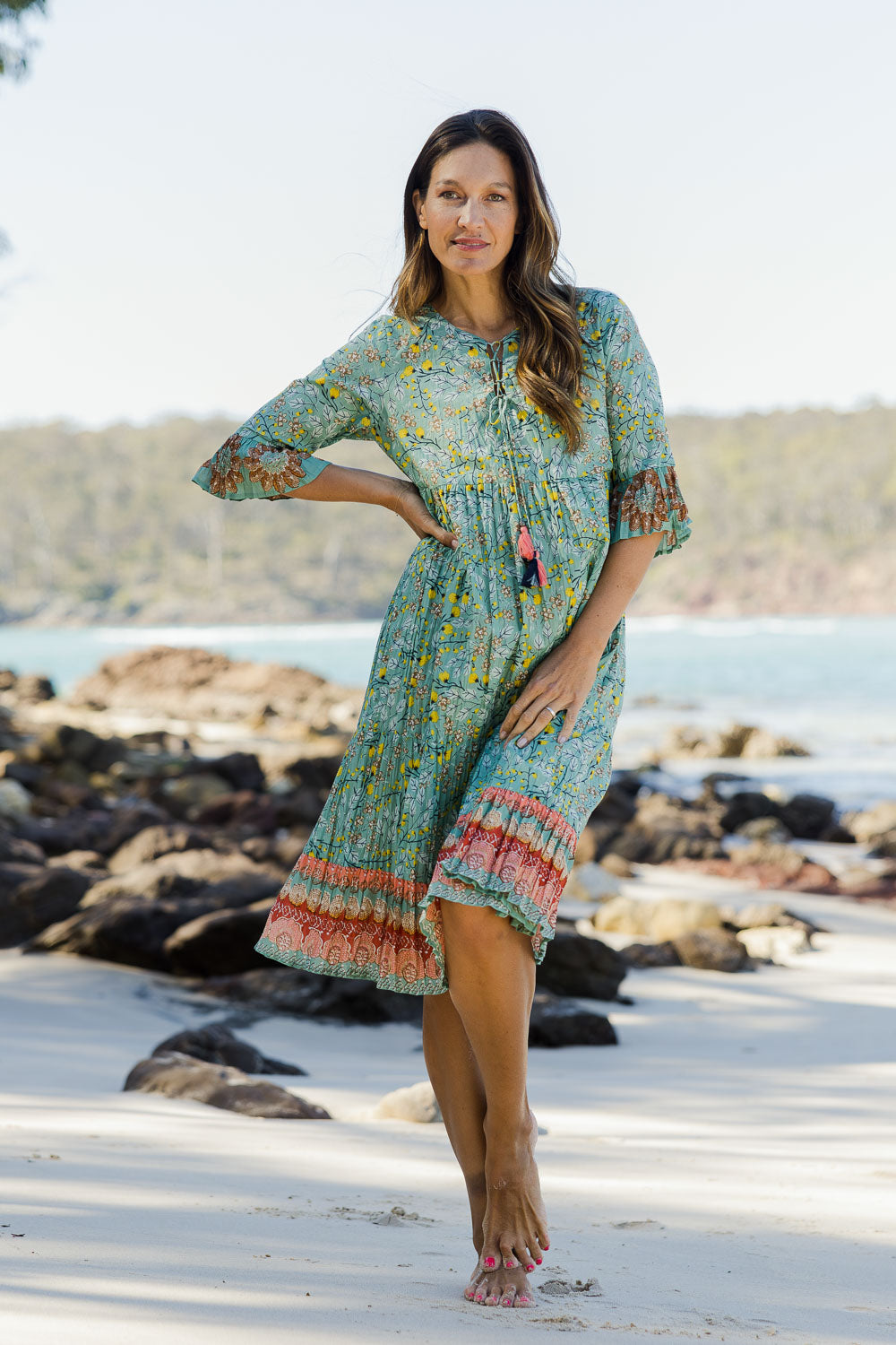 Model Alex wearing size 10 of the Chania 3/4 Sleeve Layers Dress in colour Print (Green), from the front, showing the whole outfit