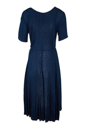 Product shot of the Essentials Godet Short Sleeve Dress in colour Navy (Blue), from the back