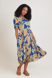 Model Ziara wearing size 10 of the Short Sleeve Godet Dress in colour Blue, from the front, showing the whole outfit