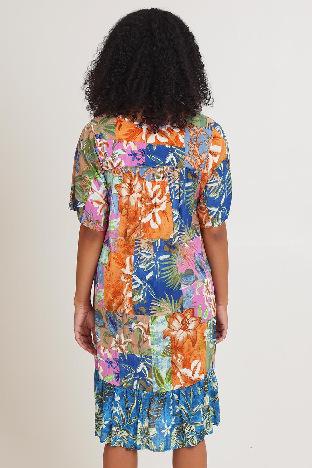 Model Ziara wearing size 10 of the Bib Dress in colour Miramir, from the back