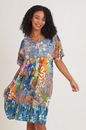 Model Ziara wearing size 10 of the Bib Dress in colour Miramir, from the front, cropped image