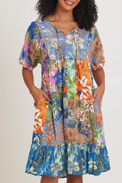 Model Ziara wearing size 10 of the Bib Dress in colour Miramir, from the front, cropped image