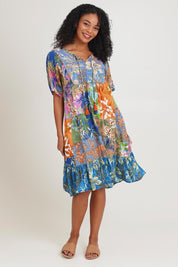 Model Ziara wearing size 10 of the Bib Dress in colour Miramir, from the front, showing the whole outfit