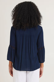 Model Ziara wearing size 10 of the Boho Top in colour Navy (Blue), from the back